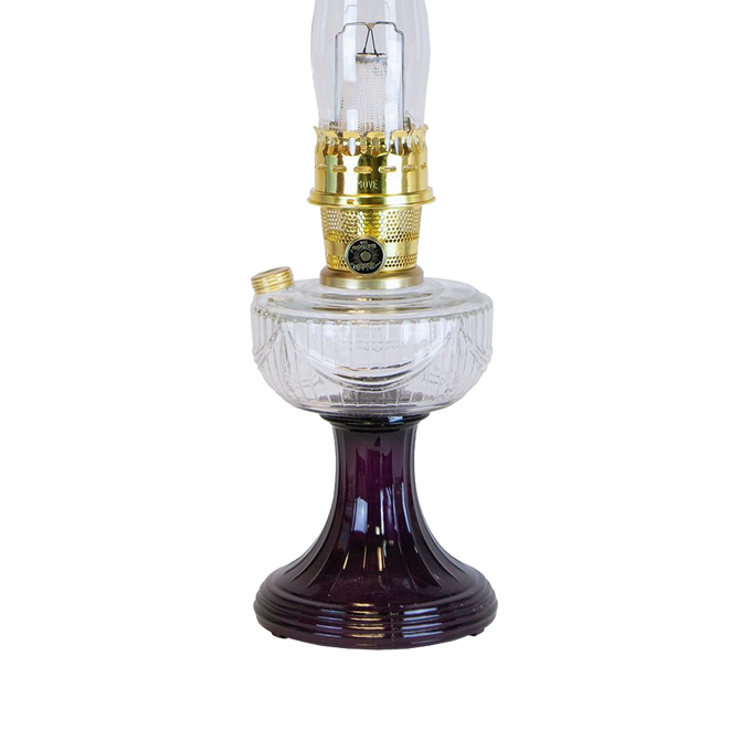 Handcrafted oil lamp featuring a clear glass font over a rich amethyst glass pedestal base with polished brass burner, ideal for Lamps & Lighting, Oil Lamps, Table Lamps, and Best Sellers collections.