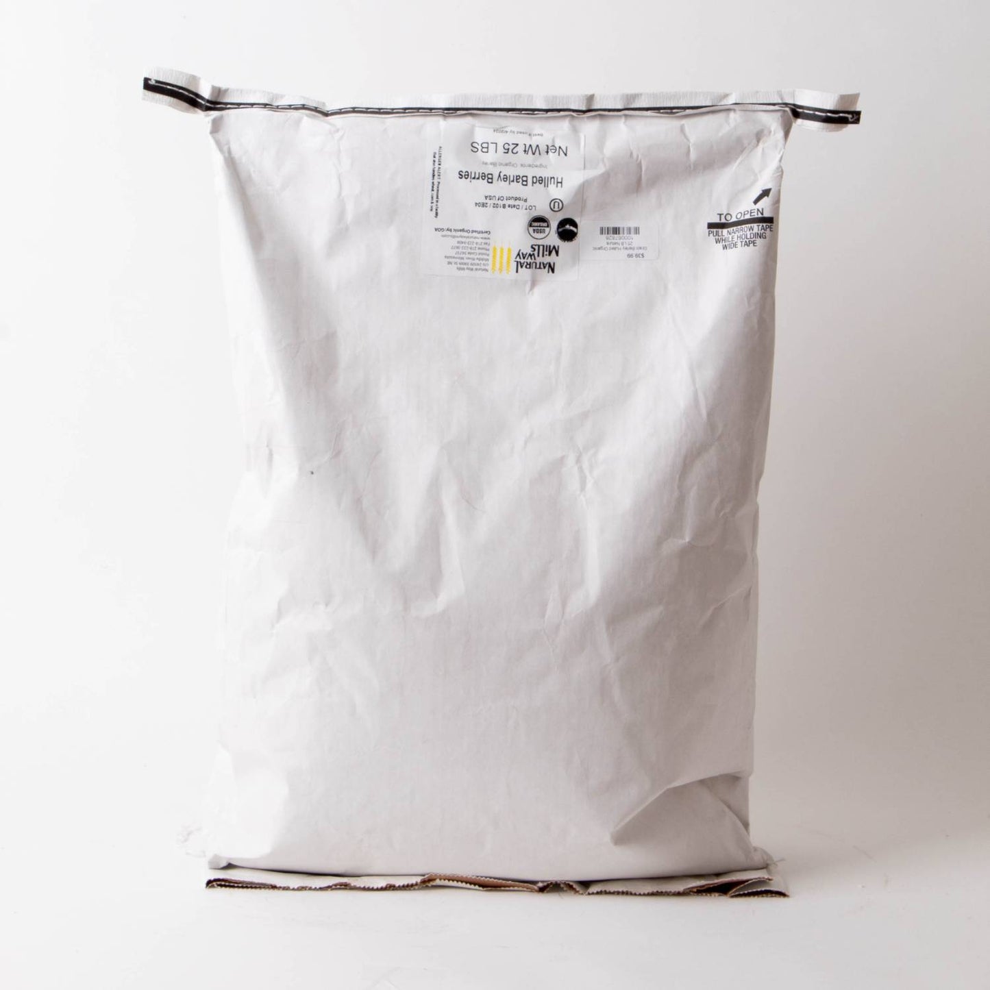Large white paper sack with printed label containing 25 pounds of organic hulled barley groats, part of pantry, kitchen, and emergency food supplies collections.