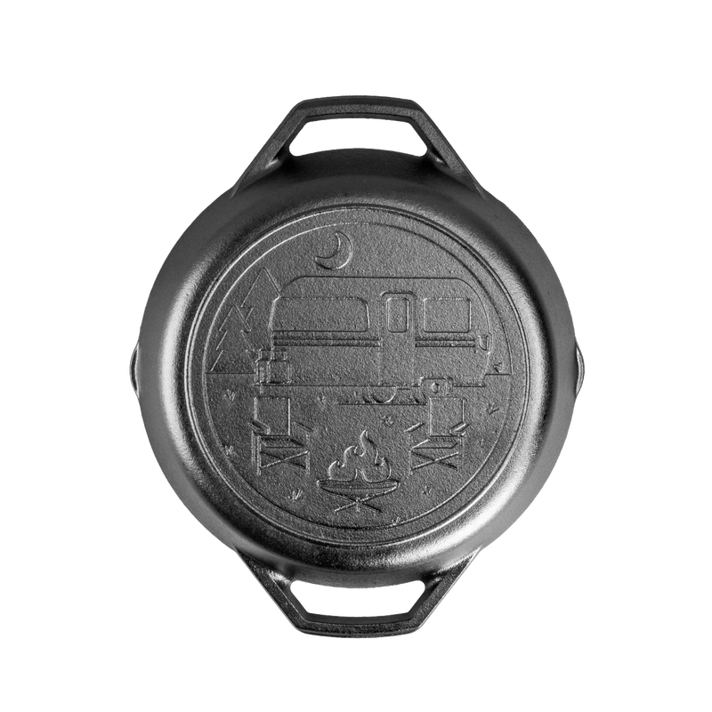 Handcrafted cast iron camper pan with dual handles, featuring a stamped campsite scene with camper, campfire, and trees, made in USA, perfect for camping and kitchen use.