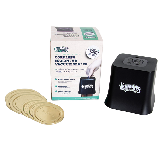 Compact black cordless vacuum sealer with digital display and one-touch operation, paired with gold-toned mason jar lids, designed for kitchen storage and food preservation collections.