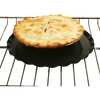 Black oven splatter guard with raised center lip and central hole for heat flow, placed on an oven rack beneath a golden-baked pie, suitable for Kitchen & Food and Kitchen Gadgets collections.