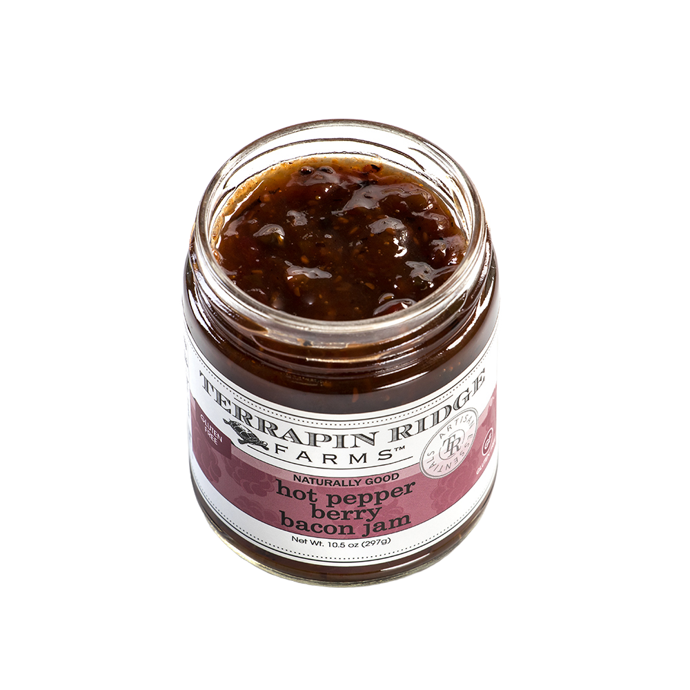 Open jar of handcrafted hot pepper bacon jam with visible textured blend, made in USA and featured in Kitchen & Food, Pantry, and Best Sellers collections.