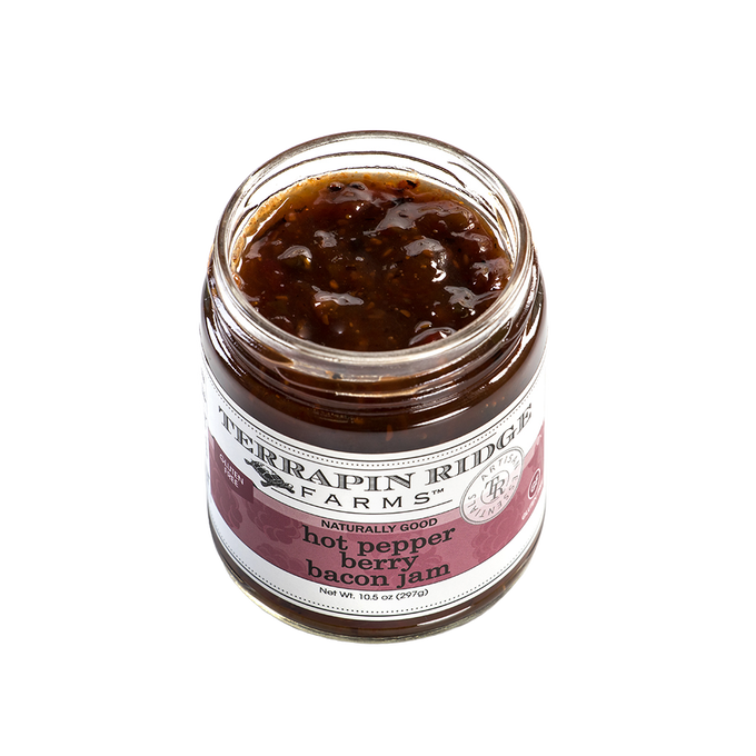 Open jar of handcrafted hot pepper bacon jam with visible textured blend, made in USA and featured in Kitchen & Food, Pantry, and Best Sellers collections.