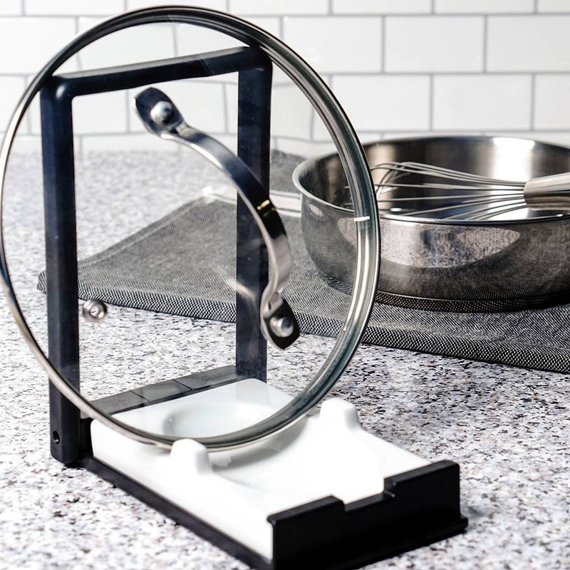 Compact two-in-one kitchen gadget with a plastic frame and white porcelain rest, designed to hold cooking spoons or securely prop pot lids, featured in Kitchen & Food and Kitchen Accessories collections.