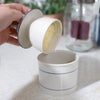 Handcrafted ceramic butter crock with simple blue line design, demonstrating butter storage by lifting the inner bowl, suitable for farm, kitchen, and homesteading collections.