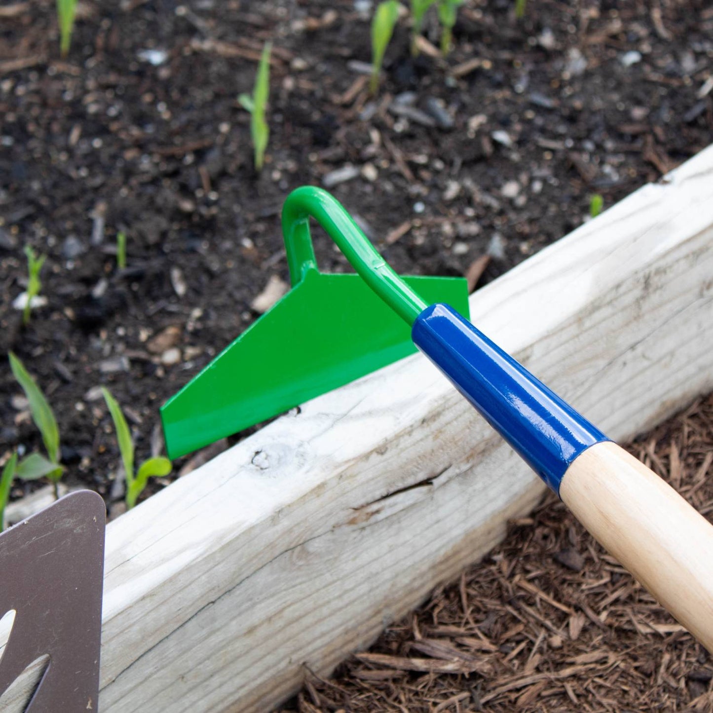 Lightweight garden hoe with a sharply honed green blade set at 70 degrees, handcrafted in the USA, ideal for weeding and cultivating in farm, garden, and digging tool collections.