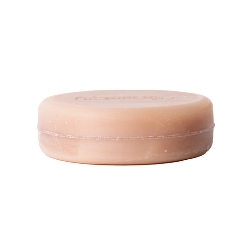 Round natural-hued shaving soap bar with subtle embossed branding, handcrafted in USA, enriched with shea butter, avocado oil, and vitamin E, featured in Health & Wellness, Grooming and Soaps collections.