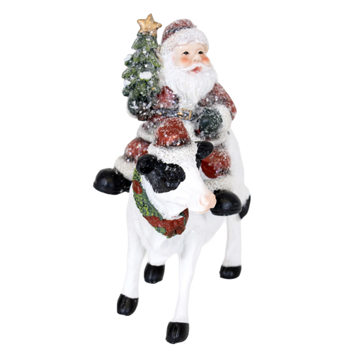 Handcrafted 6-inch resin figurine featuring Santa riding a festive cow adorned with a Christmas wreath and tree, perfect for Home & Decor, Holiday Decor, Best Sellers, and Promo Eligible collections.