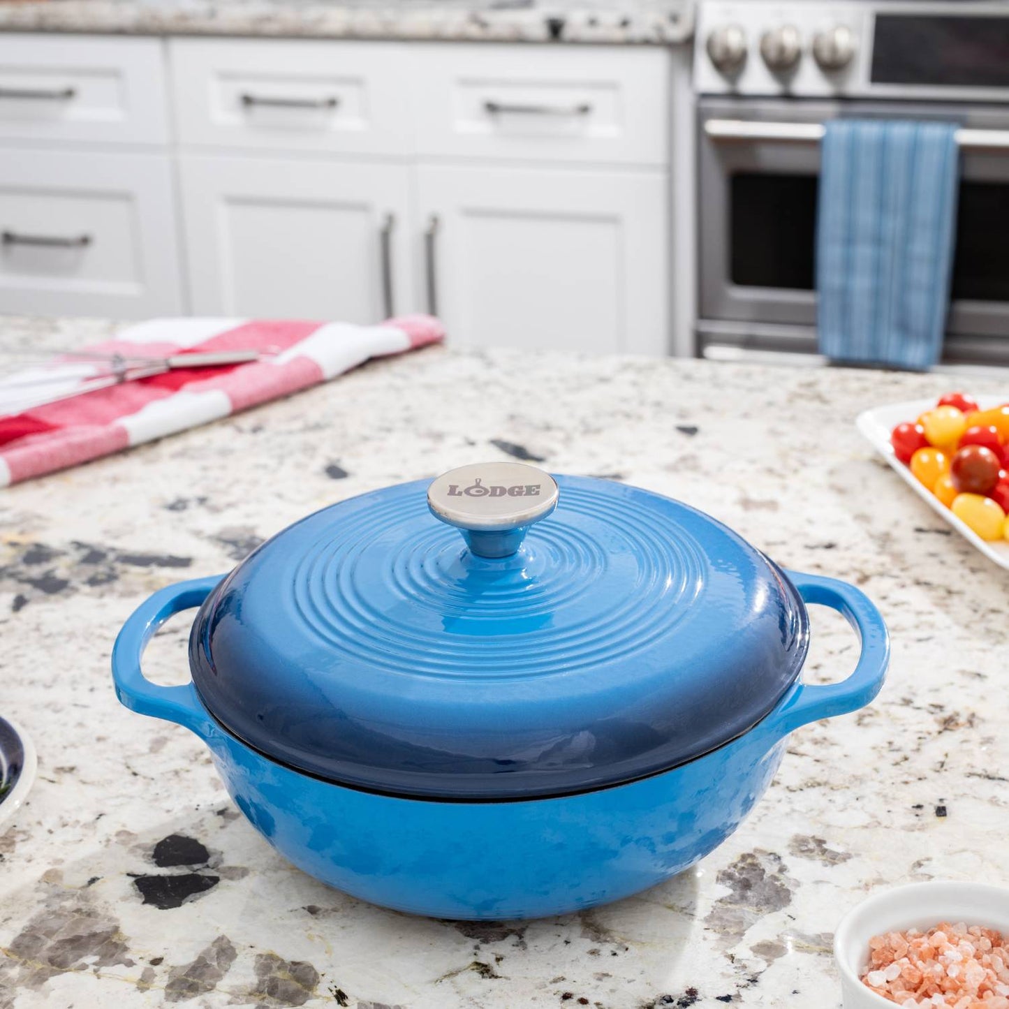 Handcrafted blue enameled cast iron Dutch oven with lid and metal knob on granite countertop, ideal for Kitchen & Food, Cookware, Cast Iron, Best Sellers, Bread Making Supplies, and Promo Eligible collections.