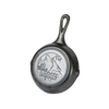 Small cast iron skillet with an embossed howling wolf and forest scene on the base, designed for Kitchen & Food, Cookware, Cast Iron, and USA Made collections.