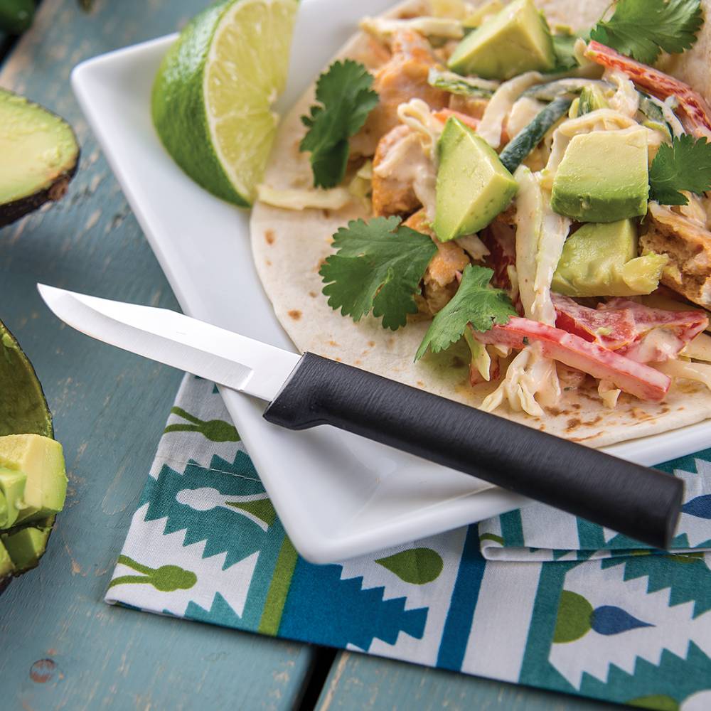 Paring knife with smooth black handle and sharp non-serrated blade, designed for precise peeling and cutting small foods, including avocados, made in USA for kitchen and food prep collections.