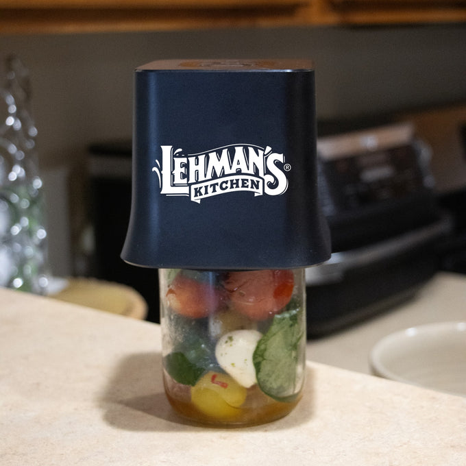 Lehman's cordless vacuum sealer in black placed on a mason jar filled with fresh vegetables, designed for easy food preservation in Kitchen & Food, Kitchen Gadgets, and Storage collections.