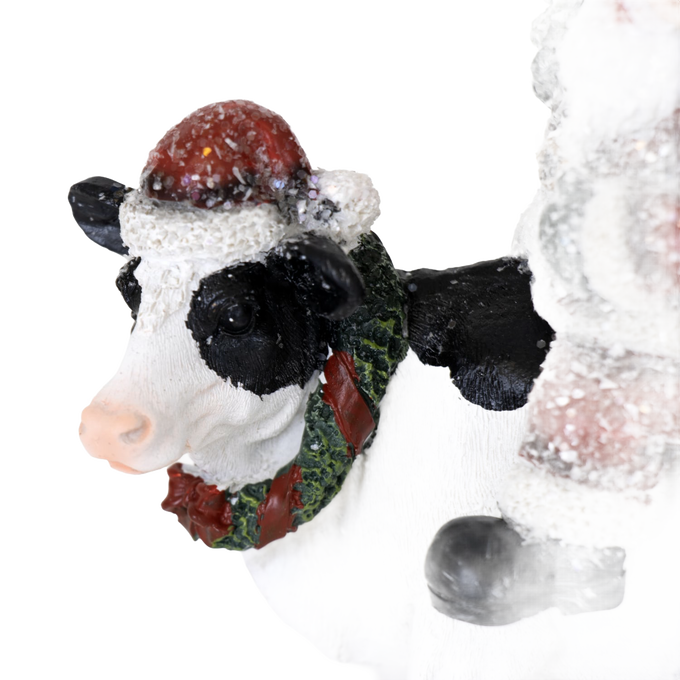 Handcrafted resin figurine featuring a whimsical cow wearing a festive wreath and Santa hat, perfect for adding country charm to Home & Decor, Holiday Decor, Best Sellers, and Promo Eligible collections.