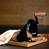 Manual bread slicer with easy hand crank and wooden handle slicing fresh homemade bread on a wooden cutting board, styled with tomatoes nearby, ideal for Kitchen & Food collections