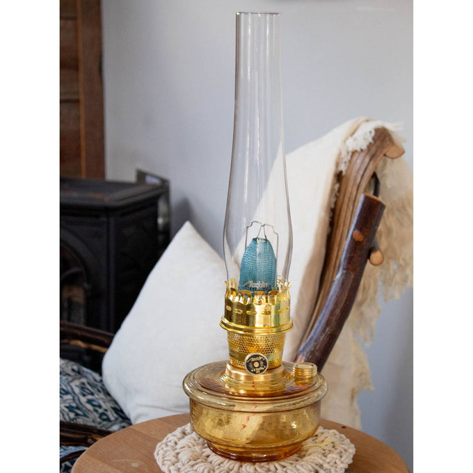 Handcrafted amber glass oil lamp with a tall clear chimney and polished brass burner, ideal for Farm, Garden & Tool, Lamps & Lighting, and Emergency Supplies collections.