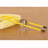 Corn stripper with stainless steel blade and yellow handles resting on wooden surface next to fresh ears of corn, perfect for Kitchen & Food, Food Prep, Choppers and Cutters, Food Preservation, Freezing, Best Sellers, and Promo Eligible collections.