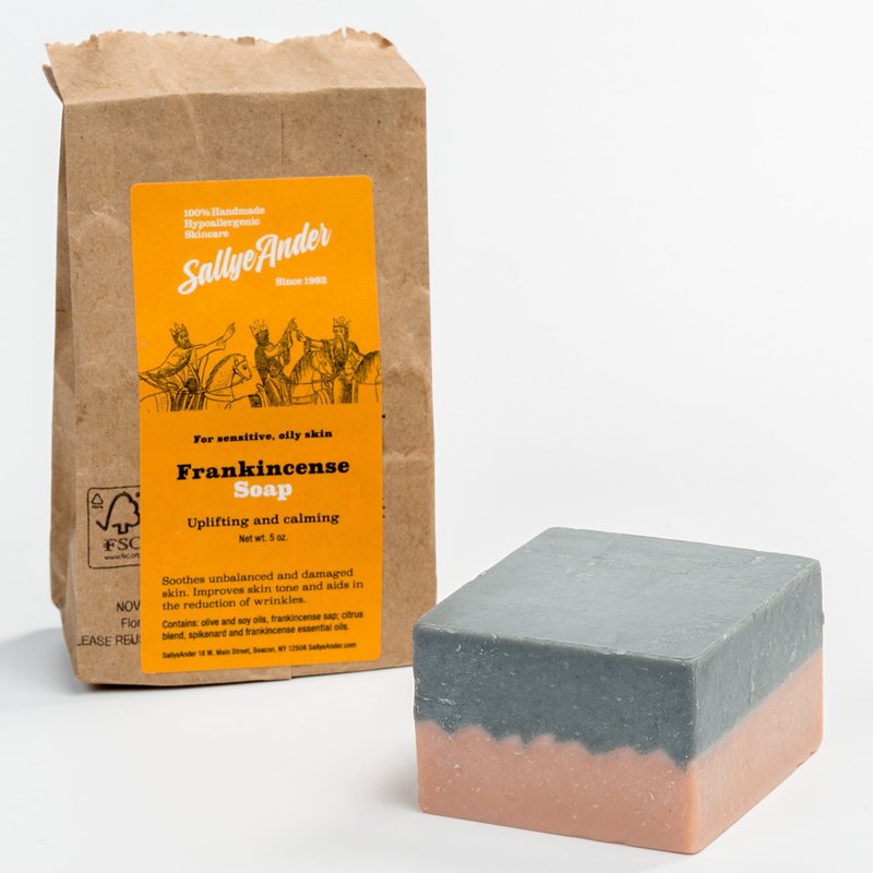 Handcrafted hypoallergenic frankincense soap bar with layered gray and soft peach tones, paired with eco-friendly kraft paper packaging, made in USA for Health & Wellness, Grooming and Personal Hygiene collections.