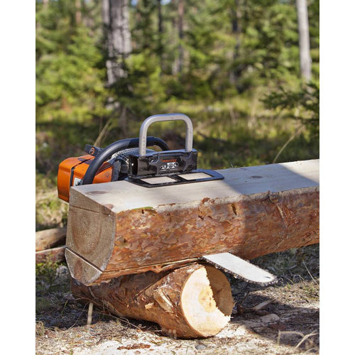 Compact portable sawmill attachment fitted onto a chainsaw cutting a large log in a wooded outdoor setting, featured in Farm, Garden & Tool and Wood Cutting and Hauling collections.
