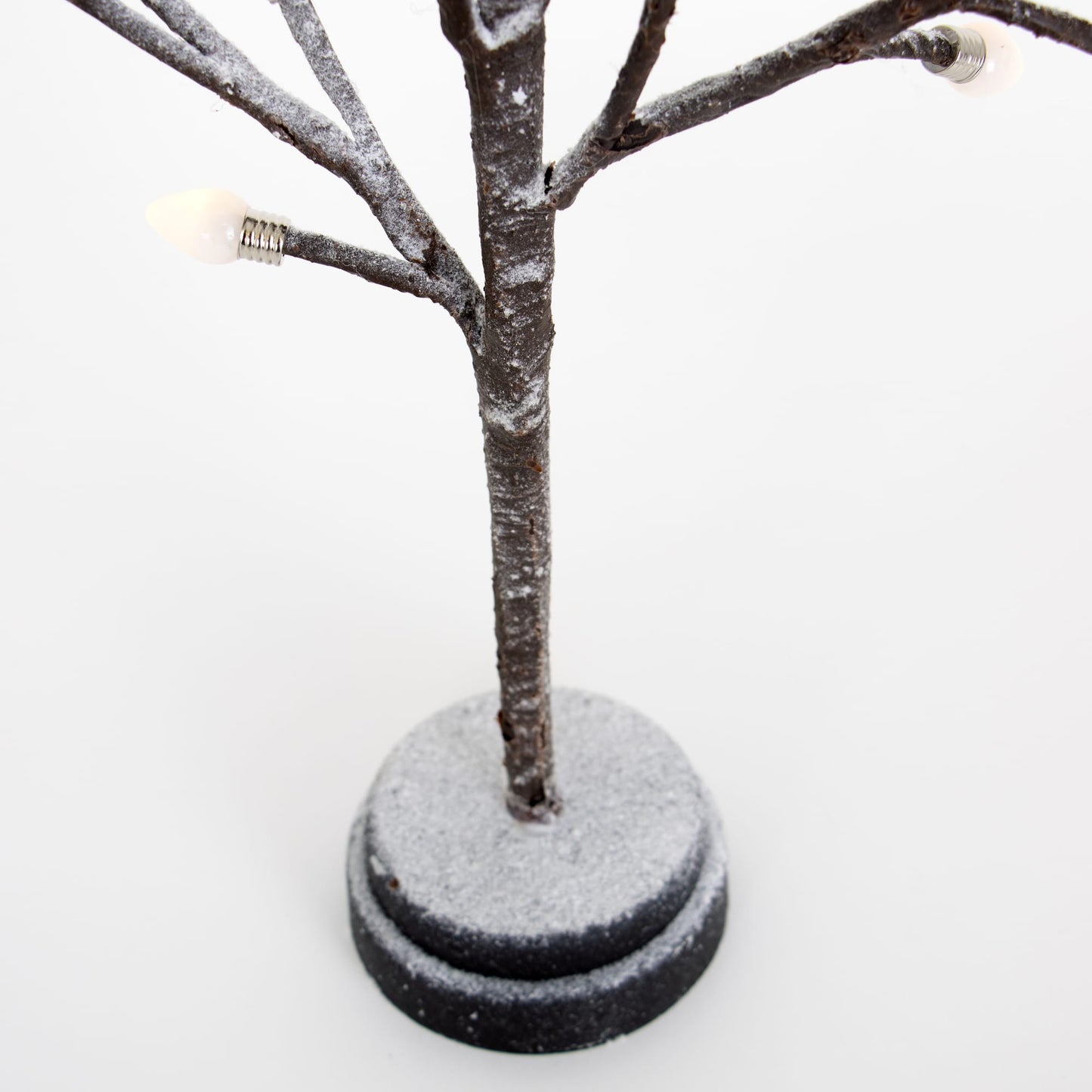 Handcrafted small decorative tree with snow-dusted branches and clear bulb caps, mounted on a round base, ideal for adding charm in Home & Decor, Holiday Decor, Best Sellers, and Promo Eligible collections.