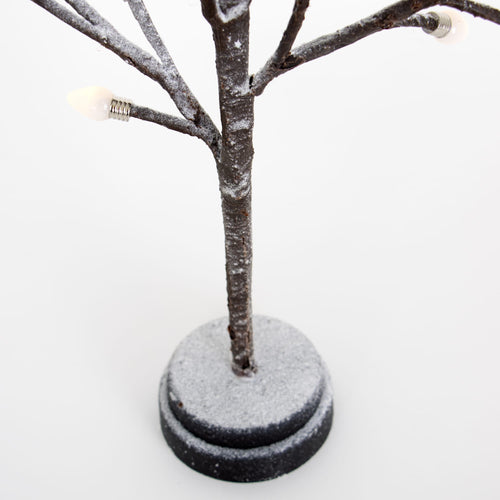 Handcrafted small decorative tree with snow-dusted branches and clear bulb caps, mounted on a round base, ideal for adding charm in Home & Decor, Holiday Decor, Best Sellers, and Promo Eligible collections.
