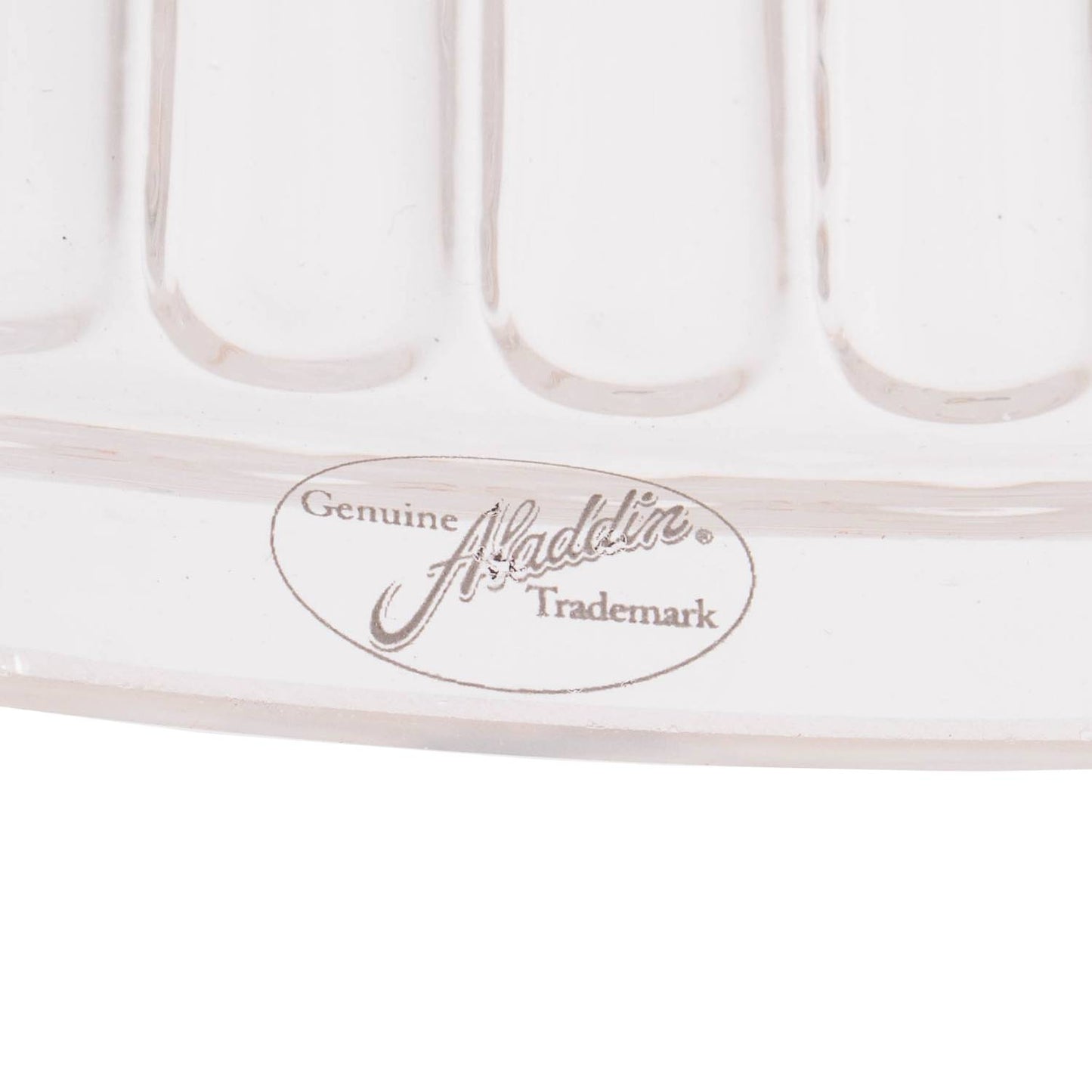 Close-up of a clear glass oil lamp shade edge with embossed Aladdin trademark, showcasing craftsmanship in lighting parts and accessories collections.