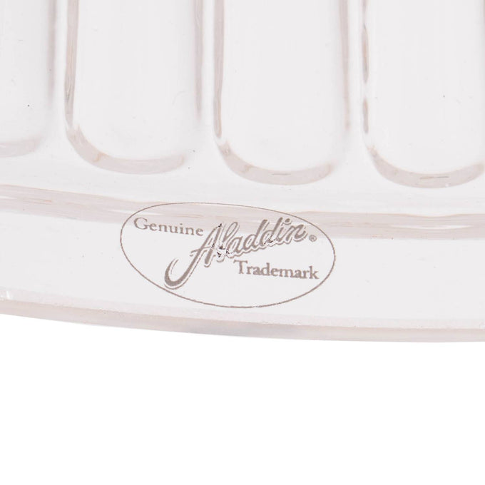 Close-up of a clear glass oil lamp shade edge with embossed Aladdin trademark, showcasing craftsmanship in lighting parts and accessories collections.