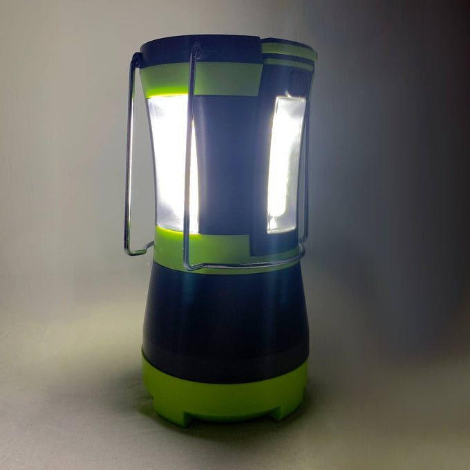 Bright LED camping lantern with sturdy metal handles and green accents, providing powerful white light for use in emergency supplies, outdoor, and battery-powered lighting collections.