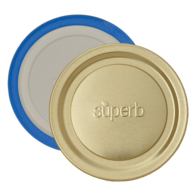 Close-up of two wide-mouth canning jar lids with one gold-colored lid embossed with "superb" and one inner sealing lid featuring a blue ring, highlighting durable design for food preservation and canning collections.