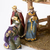 Set of three handcrafted resin wise men figurines with detailed golden accents and colorful robes, arranged beside a moss-covered stable for Home & Decor, Holiday Decor, Best Sellers, Promo Eligible collections.