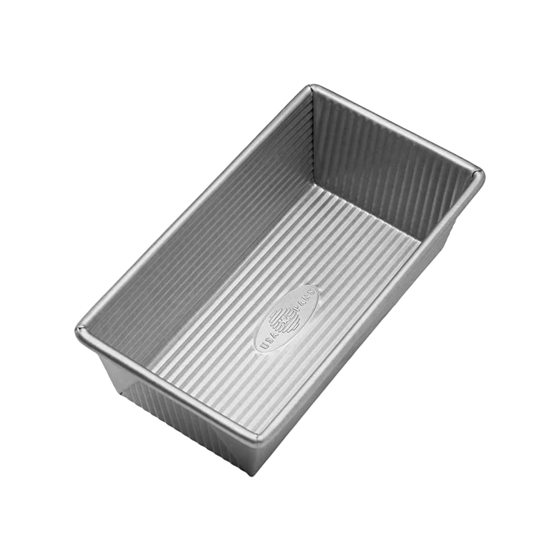 Rectangular non-stick aluminized steel loaf pan with corrugated surface for even baking, handcrafted in the USA, featured in Kitchen & Food, Cookware, Baking Supplies, and Bread Making Supplies collections.