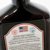 Close-up of a dark amber bottle label highlighting sulfate-free and paraben-free claims, made in USA, promoting natural insect repellent and dermatologist-recommended scalp care in Health & Wellness and Grooming collections.