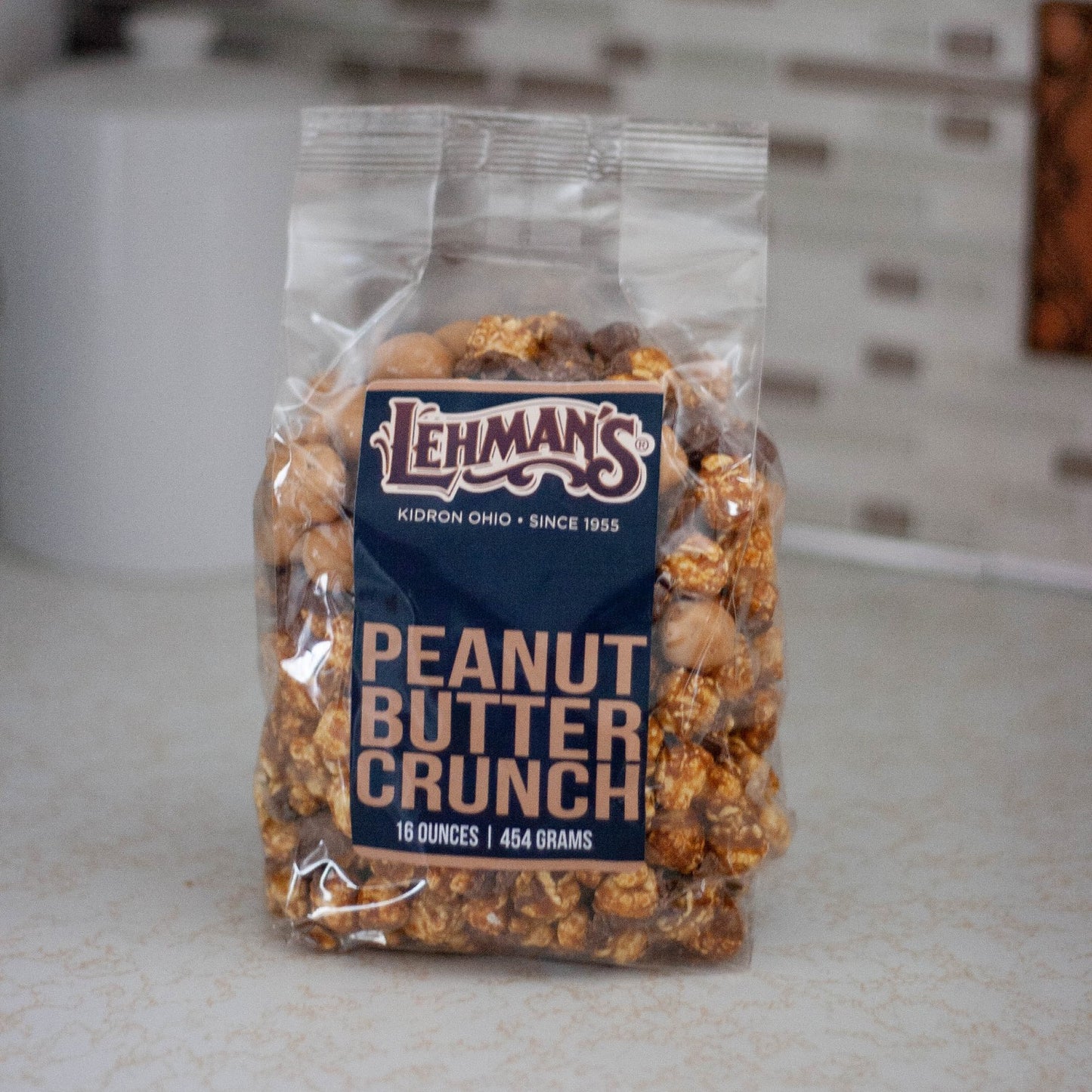 Clear bag of handcrafted peanut butter crunch popcorn, a unique sweet and crunchy snack made in USA, perfect for Kitchen & Food, Snacks and Sweets, Popcorn, USA Made, and Best Sellers collections.