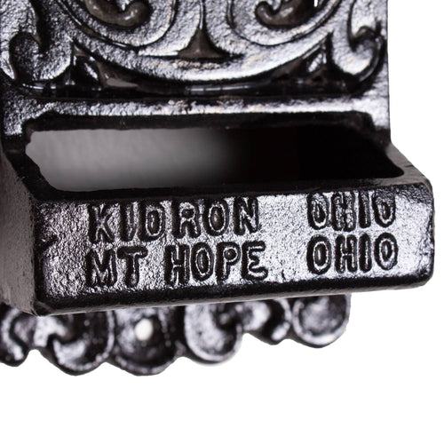 Close-up of handcrafted black cast iron wall-mounted matchbox holder showing embossed "Kuoron Ohio Mt Hope Ohio" with vintage decorative scrollwork, made in USA, ideal for Home & Decor, Household Helpers, and Best Sellers collections.