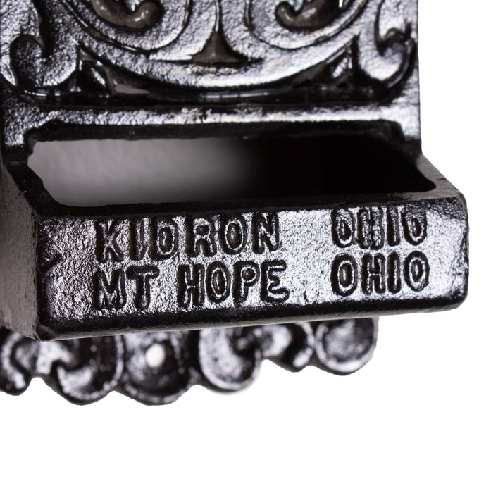 Close-up of handcrafted black cast iron wall-mounted matchbox holder showing embossed "Kuoron Ohio Mt Hope Ohio" with vintage decorative scrollwork, made in USA, ideal for Home & Decor, Household Helpers, and Best Sellers collections.