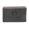 Rectangular dark brown bar of soap embossed with a handmade natural logo, representing an organic, handcrafted Ayurvedic soap ideal for health and wellness collections.