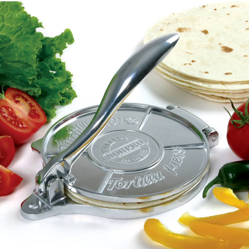 Cast aluminum tortilla press with a smooth handle for even dough pressing, surrounded by fresh vegetables and stacked tortillas, ideal for Kitchen & Food, Cookware, Baking Supplies, Best Sellers, and Promo Eligible collections.