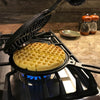 Handcrafted stovetop cast iron waffle maker with detachable halves cooking a round waffle over a gas stove, featured in Farm, Garden & Tool, Kitchen & Food, and Cast Iron collections.