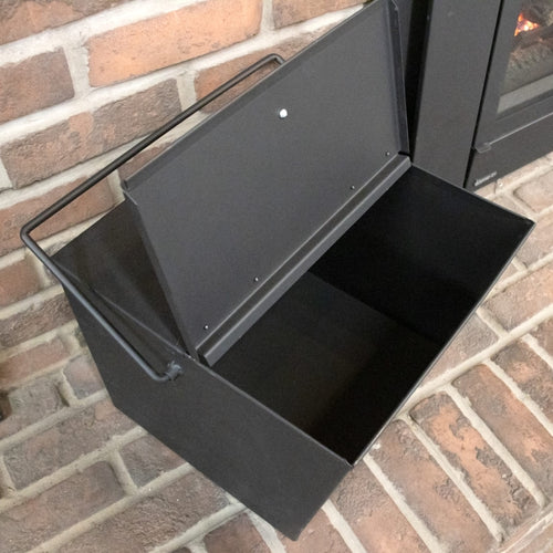 Heavy-duty steel ash carrier bucket with hinged lid and balanced handle, featuring sturdy legs and assist handle for easy dumping, suitable for Stoves, USA Made, Hearth Accessories, and Best Sellers collections.