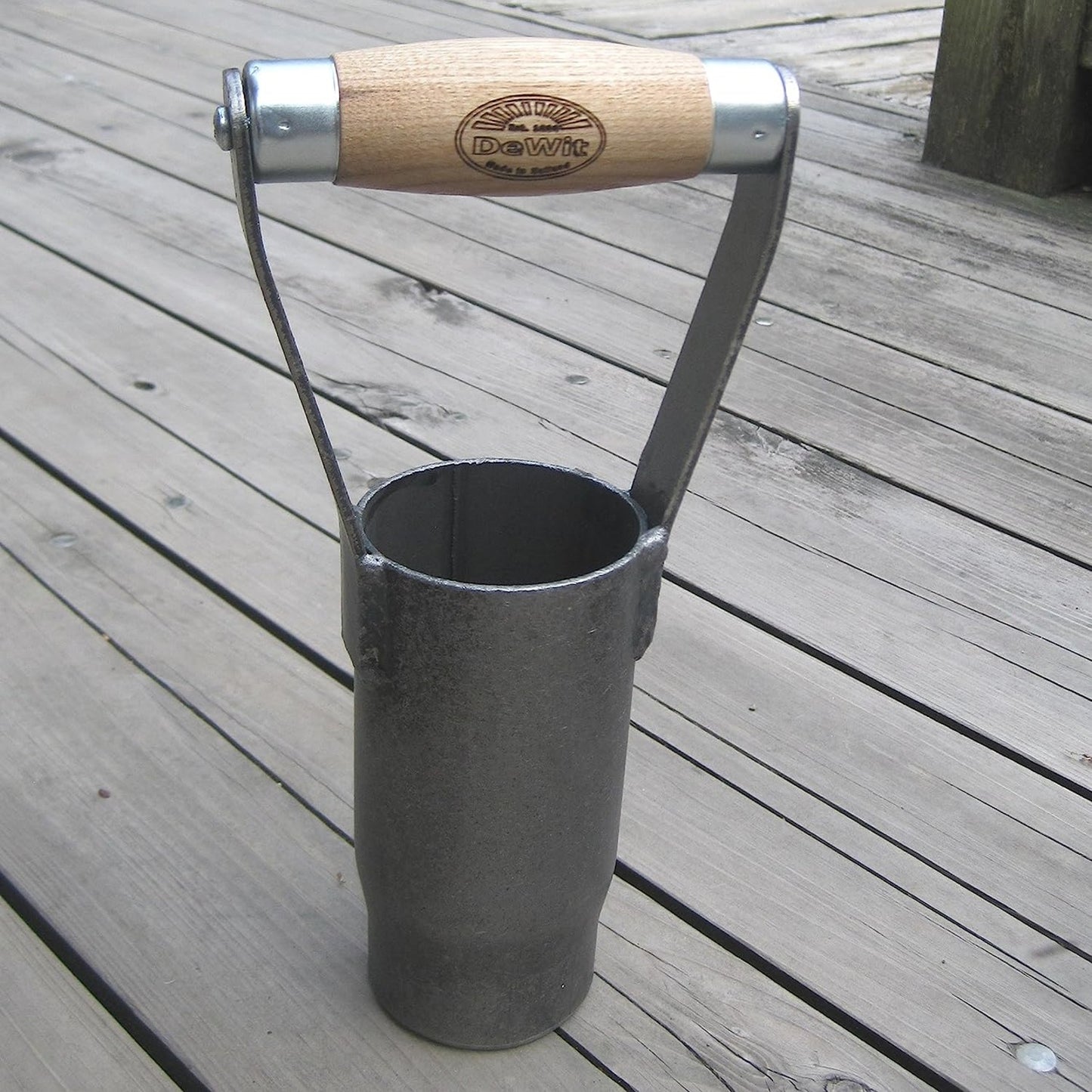 Handcrafted British style bulb planter with a sharp cutting edge and sustainably made ash wood handle, designed for easy soil extraction in farm and garden use.