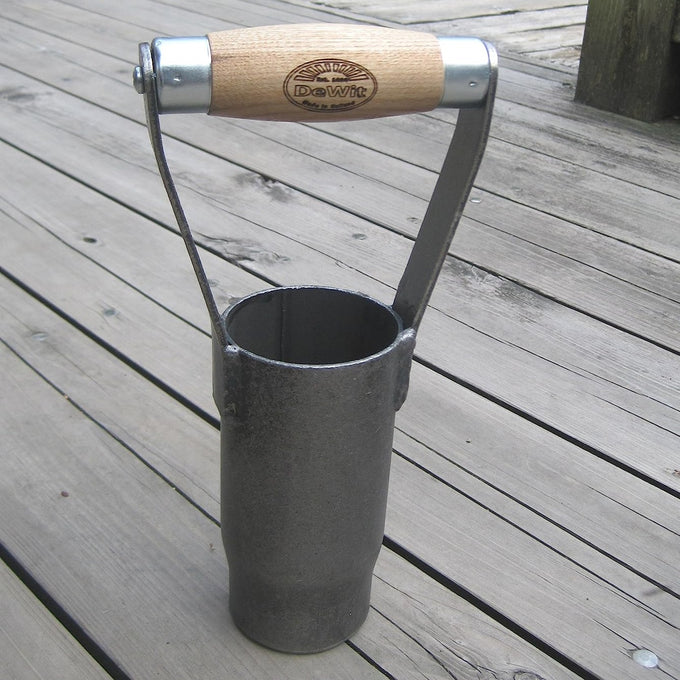 Handcrafted British style bulb planter with a sharp cutting edge and sustainably made ash wood handle, designed for easy soil extraction in farm and garden use.