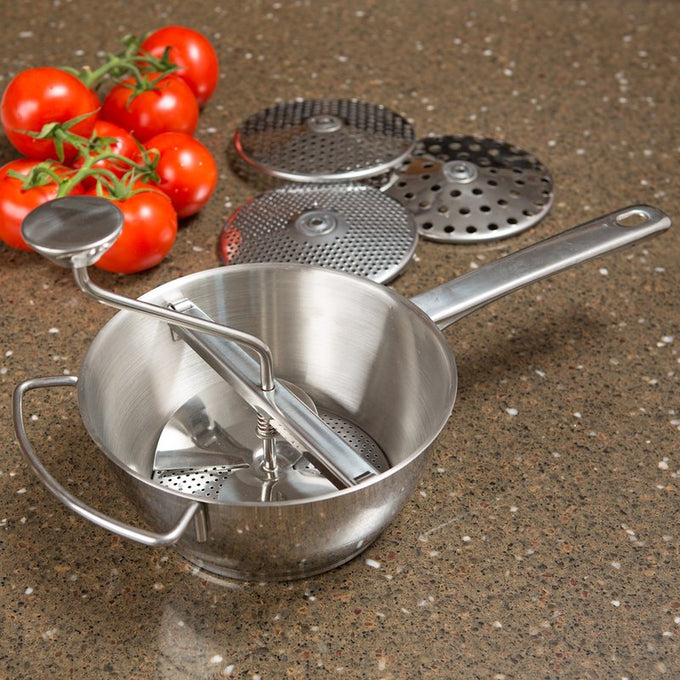 Handcrafted 2-quart stainless steel food mill with a crank handle and four interchangeable discs, perfect for food prep in kitchen, farm, and homesteading collections.