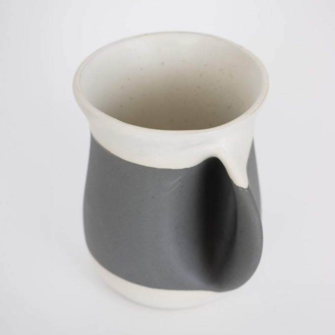 Handcrafted gray ceramic mug with a built-in handwarmer pocket and smooth white rim, designed for cozy use in Kitchen & Food, Dinnerware, Best Sellers, and Promo Eligible collections.