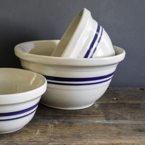 Set of durable cream-colored stoneware mixing bowls with double blue stripes, handcrafted in the USA, ideal for Kitchen & Food, Cookware, Baking Supplies, and Storage and Serving collections.