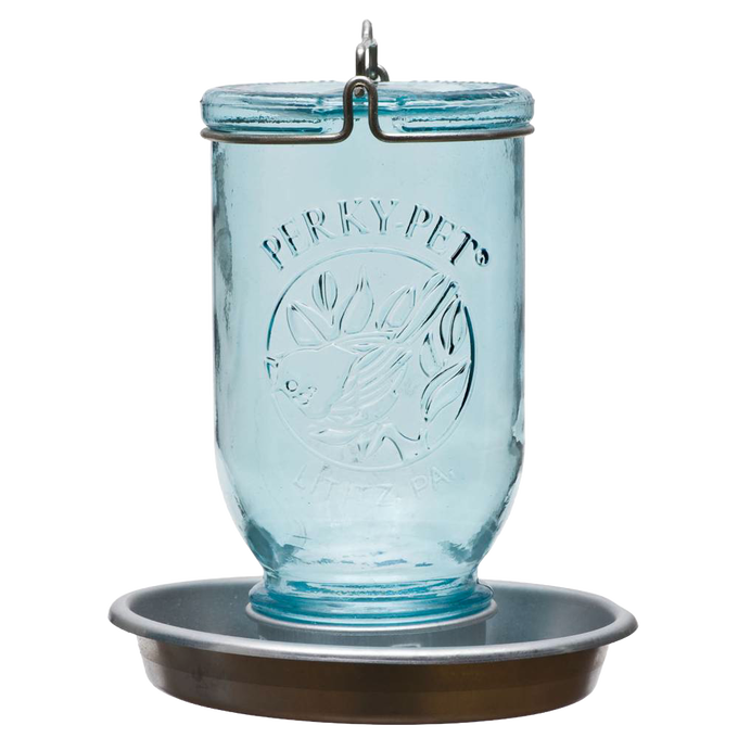 Antique-style blue glass Mason jar with embossed bird and leaf design, featuring a galvanized metal base and circular perch, handcrafted for farm, garden, and animal care use.