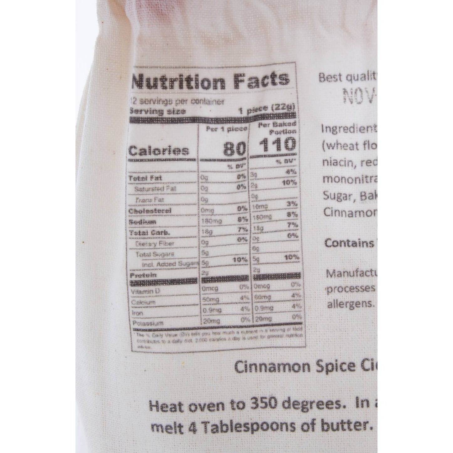 Close-up of a fabric bag displaying nutritional information and baking instructions for a handcrafted cinnamon spice bread mix, suitable for Kitchen & Food, Pantry, Dry Goods and Mixes, Best Sellers, and Promo Eligible collections.
