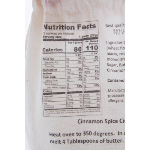 Close-up of a fabric bag displaying nutritional information and baking instructions for a handcrafted cinnamon spice bread mix, suitable for Kitchen & Food, Pantry, Dry Goods and Mixes, Best Sellers, and Promo Eligible collections.