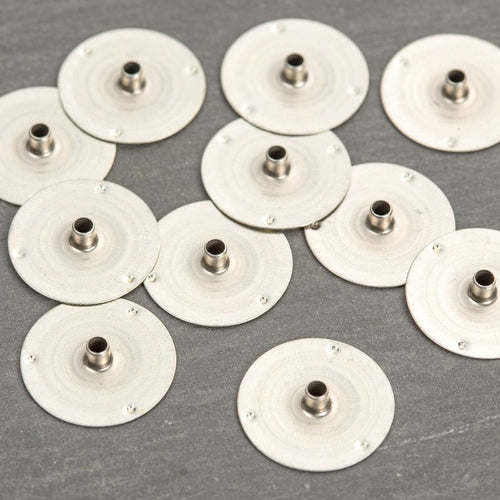 Small metal wick tabs with a 9/16 inch base, designed for use in container or votive candles, made in USA, featured in Lamps & Lighting and Candlemaking Supplies collections.