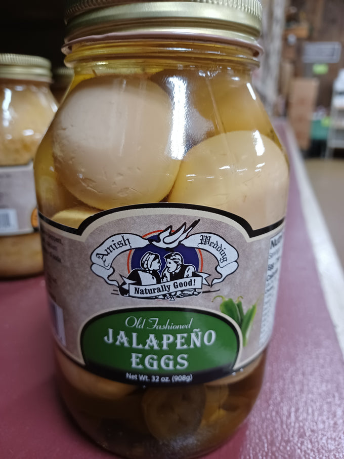 Glass jar of handcrafted jalapeño marinated eggs in clear brine with vintage-style Amish Wedding label and metal lid, made in USA, ideal for Kitchen & Food, Food, Pantry, USA Made, Best Sellers, and Promo Eligible collections.