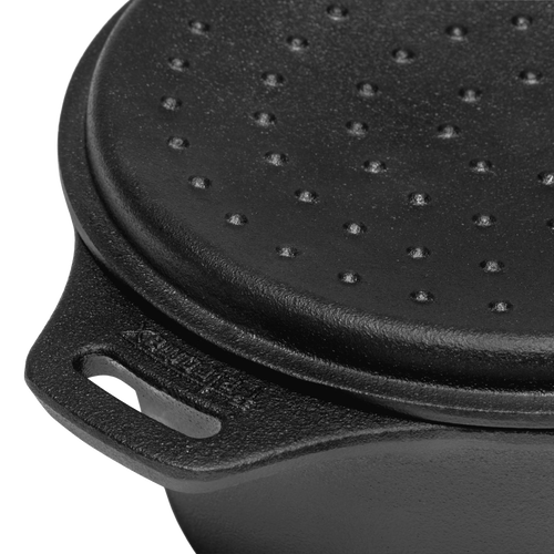 Close-up of the self-basting lid on a durable cast iron saucepan, featuring raised bumps and a sturdy handle, ideal for outdoor cooking in camping, farm, garden, and cookware collections.