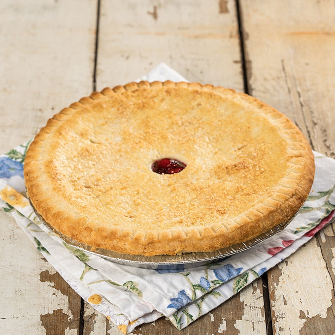 Handcrafted American cherry pie with a golden crust and a small vent revealing rich cherry filling, perfect for Kitchen & Food, Snacks and Sweets, USA Made, and Best Sellers collections.